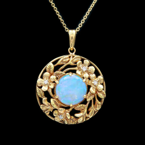 an opalite and diamond pendant on a chain