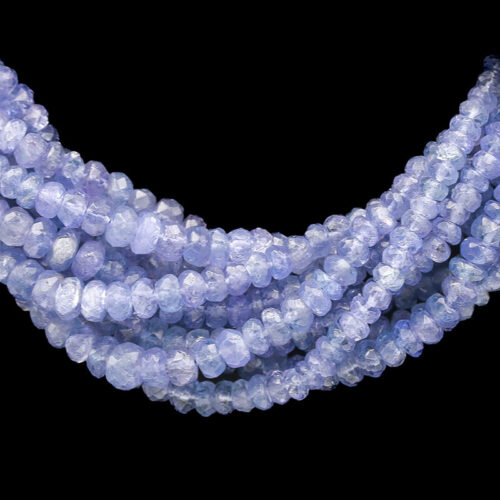 a strand of light blue glass beads on a black background