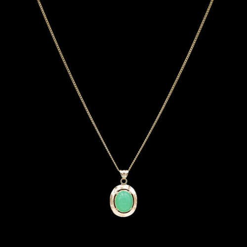 a necklace with a green stone in the center