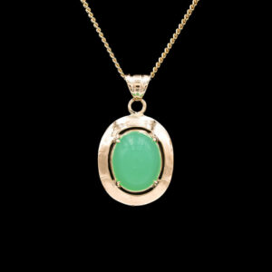 a pendant with a green stone in the center