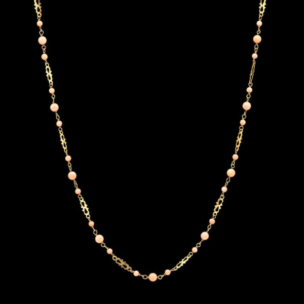 a gold chain with pink beads on it