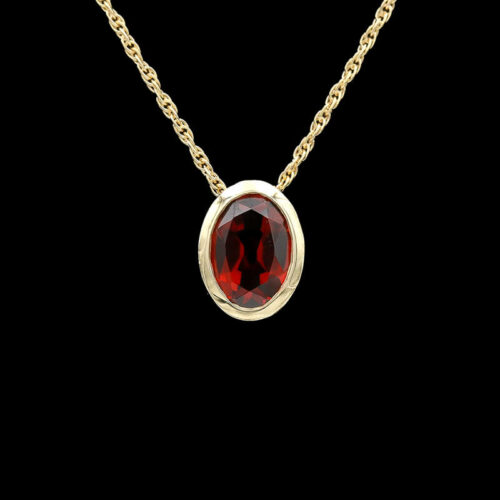 a necklace with a red stone in the center