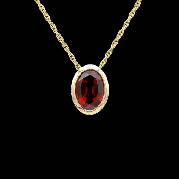 a necklace with a red stone in the center