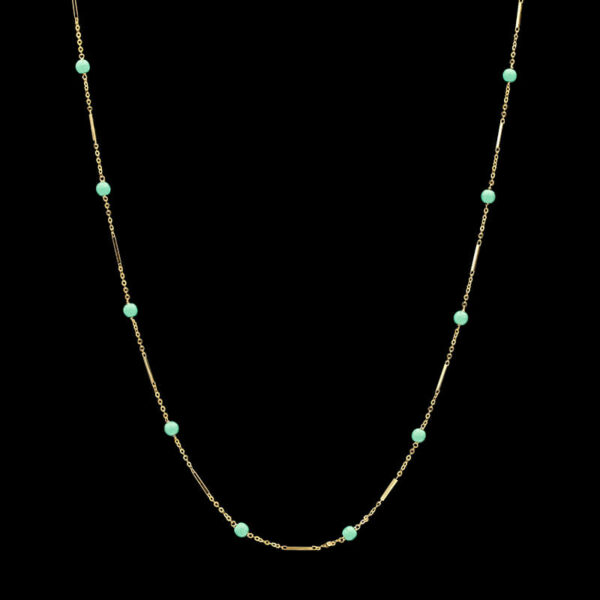a gold necklace with turquoise beads