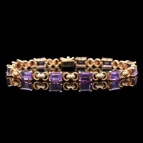 a gold bracelet with purple stones