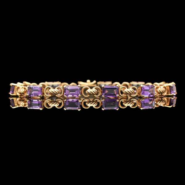 a gold bracelet with amethorate stones