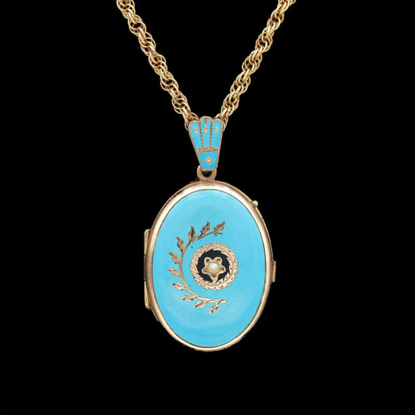 a blue and gold locke necklace with a flower on it