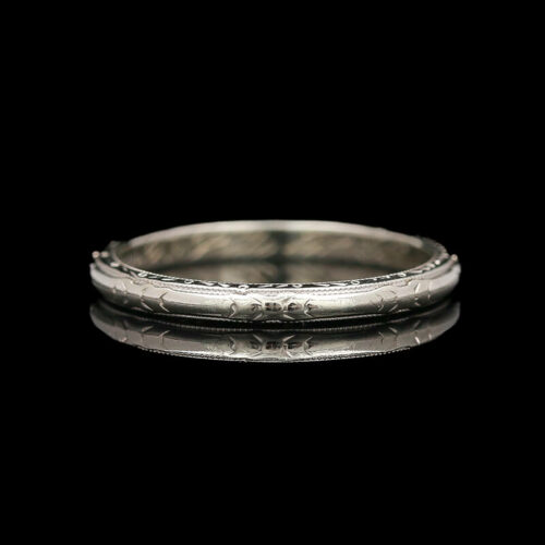 a silver ring on a black background