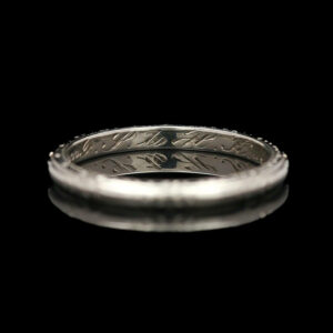 a silver ring with an arrow on it