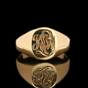 a gold monogrammed signet ring with the initials