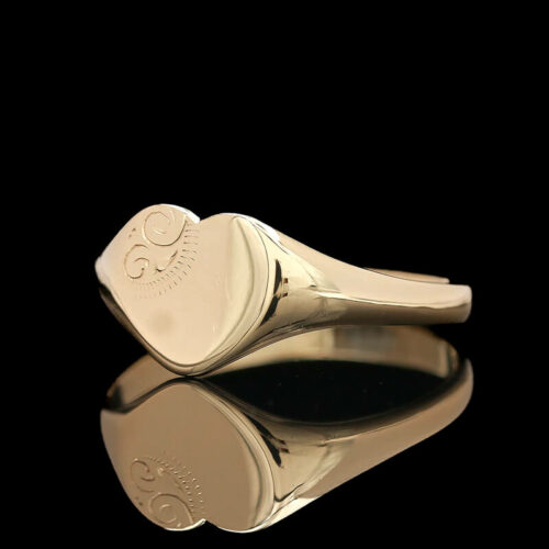 a gold ring with a heart on it