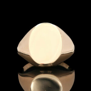 a silver ring sitting on top of a reflective surface