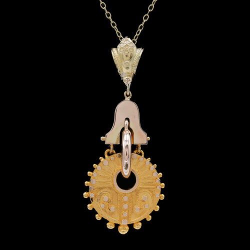 a gold and silver necklace with a bell on it
