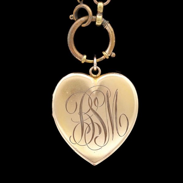 a heart shaped locke with a monogrammed initials