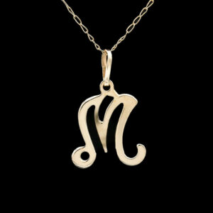 a gold pendant with the letter m on it