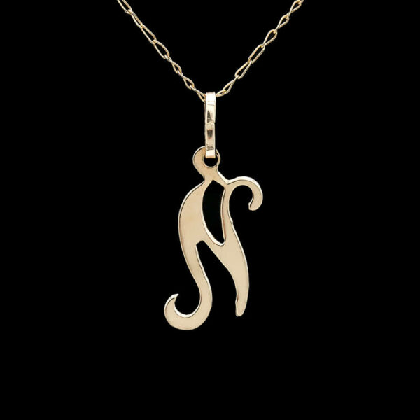 a gold necklace with a letter on it
