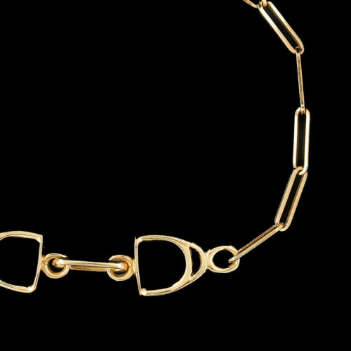a gold necklace with two hearts and links