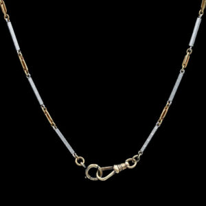 a long necklace with two tone gold and silver links