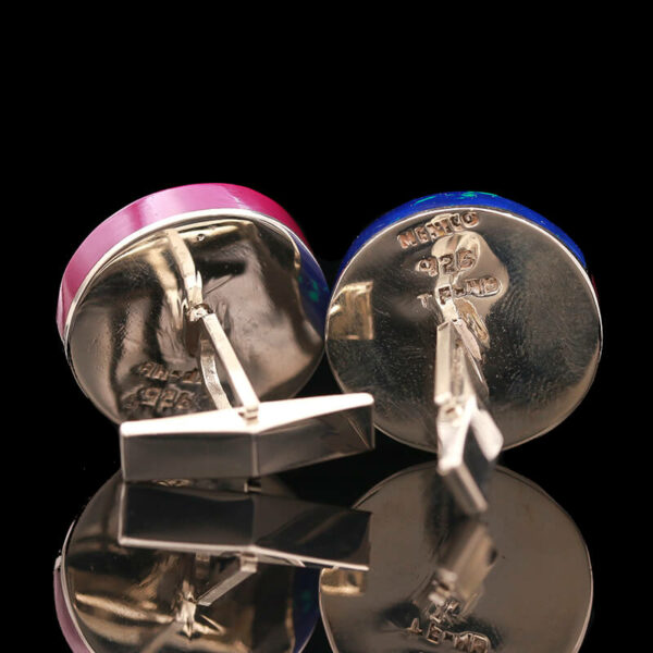 a pair of cufflinks with pink and blue enamel