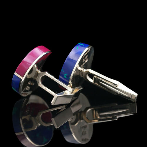 a pair of cufflinks with colorful bands on them