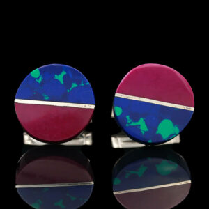 two cufflinks with blue, red and green designs