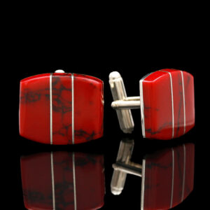 a pair of red and white cuff links