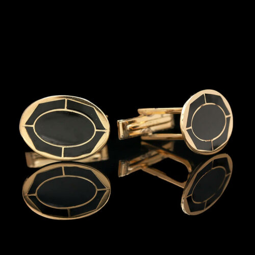 a pair of black and gold cufflinks