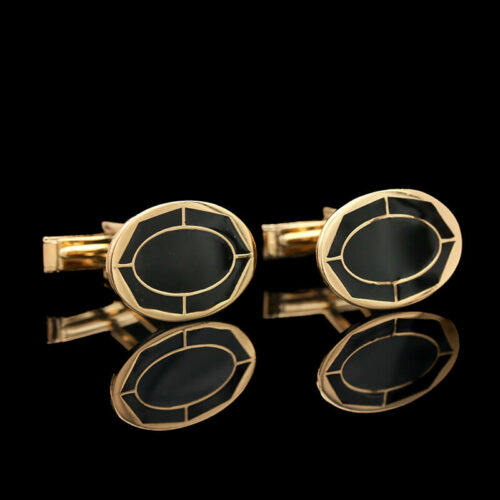 a pair of black and gold cufflinks
