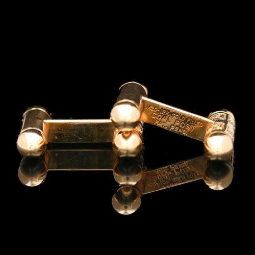 a pair of gold cufflinks with roman numerals