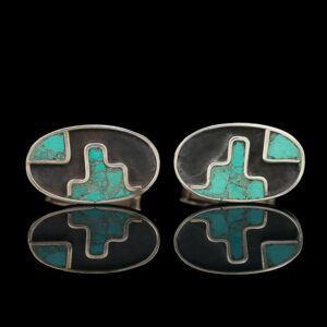 a pair of turquoise and black cufflinks