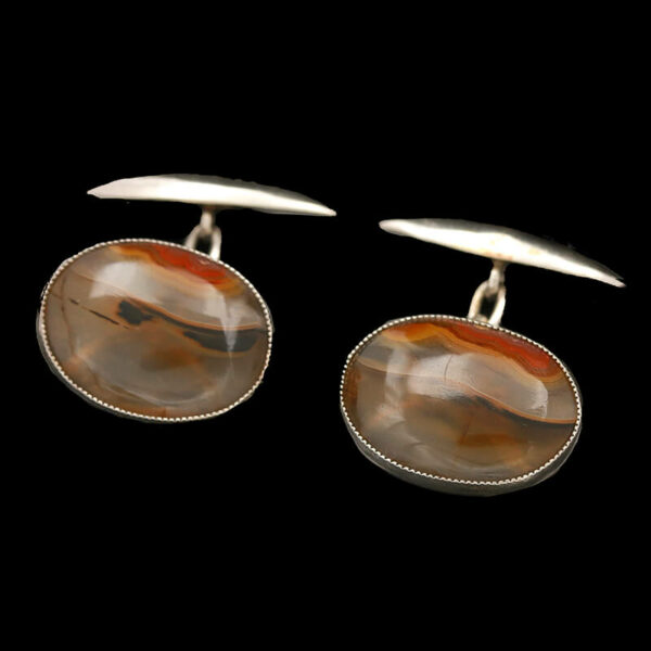 a pair of silver and tortoise shell cufflinks