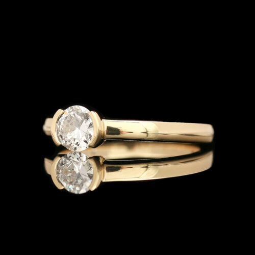 a gold ring with two diamonds on it