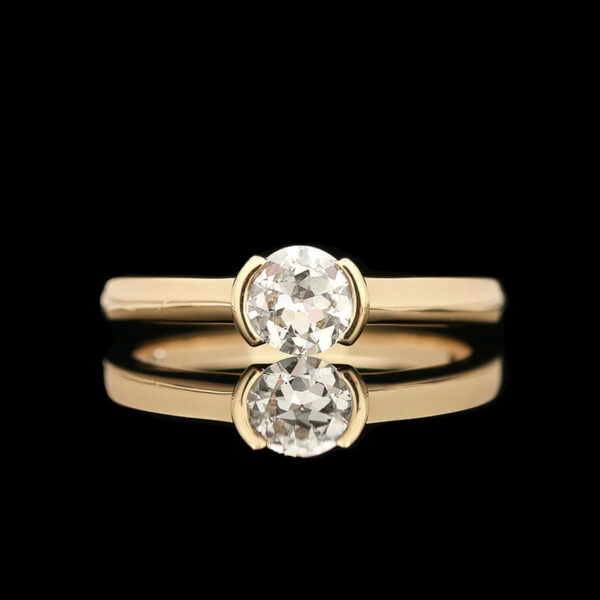 a yellow gold ring with an oval cut diamond