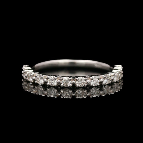 a wedding ring with diamonds on a black background