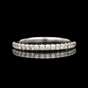 a diamond wedding ring on a black background
