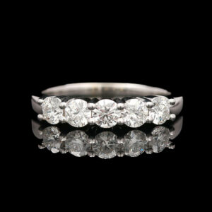 a five stone diamond ring on a black background