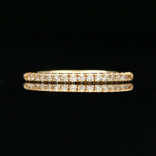 a gold ring with three rows of diamonds