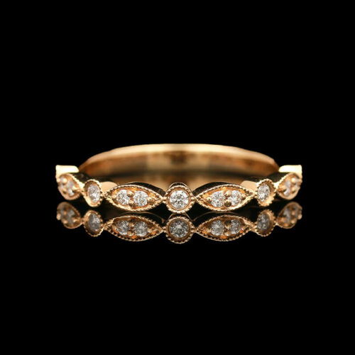a yellow gold ring with diamonds