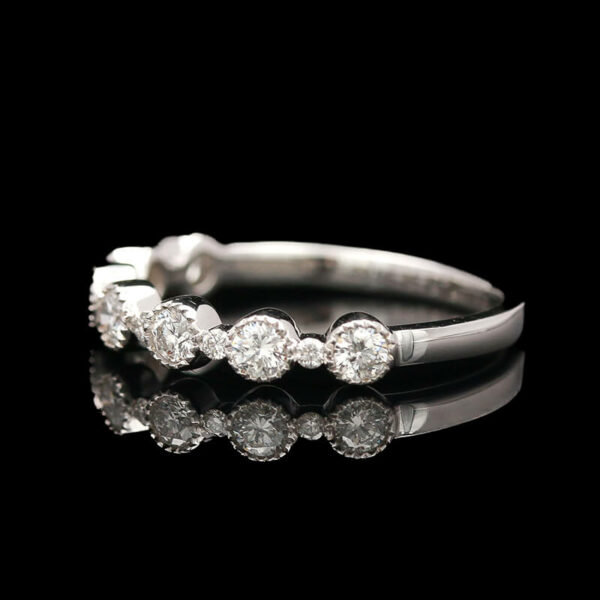 a white gold ring with five diamonds