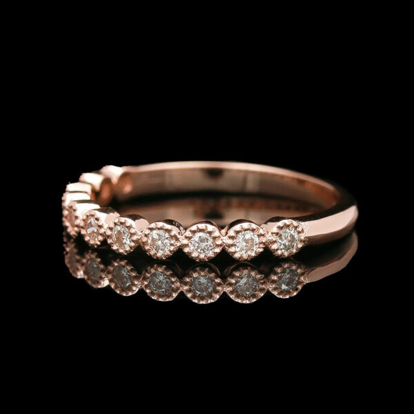 a rose gold ring with five diamonds