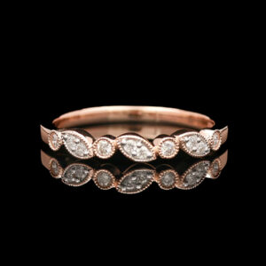 a rose gold ring with three diamonds