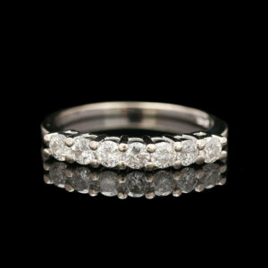 a wedding ring with five diamonds on it