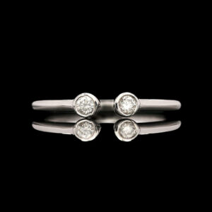 two white gold diamond rings on a black background