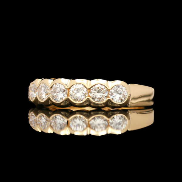 a yellow gold ring with five round diamonds