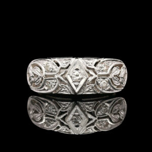 a silver ring with intricate designs on it
