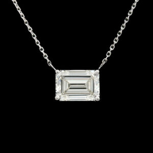 a necklace with an emerald cut diamond on it