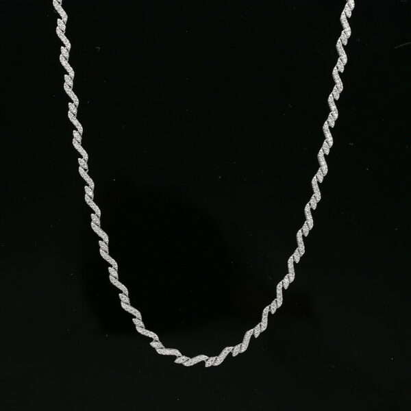 a white necklace on a black background