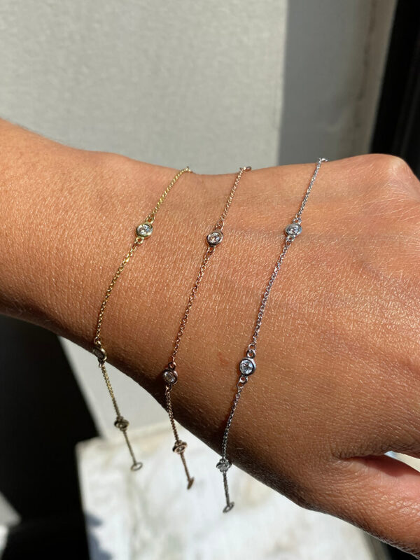 a woman's arm with three different bracelets on it