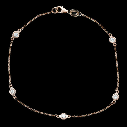 a gold bracelet with white stones