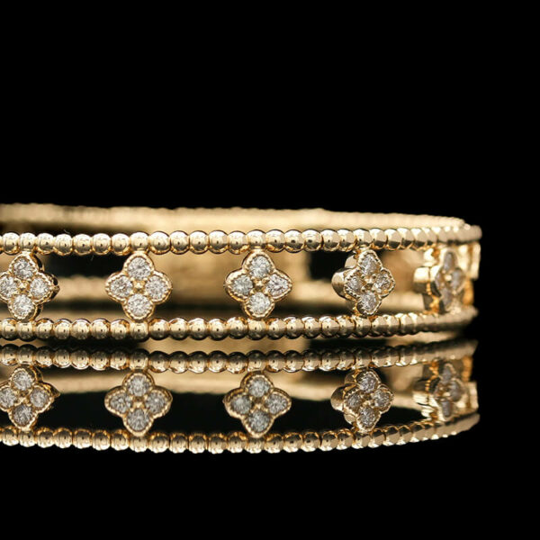 a close up of a gold ring with diamonds